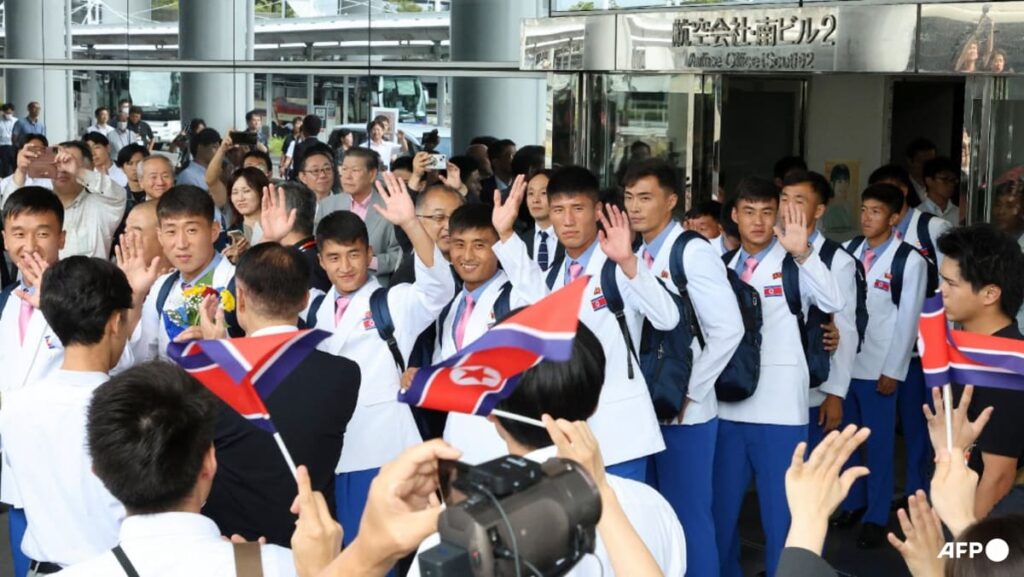 White blazers, pink ties as North Koreans land in Japan for Asian Games