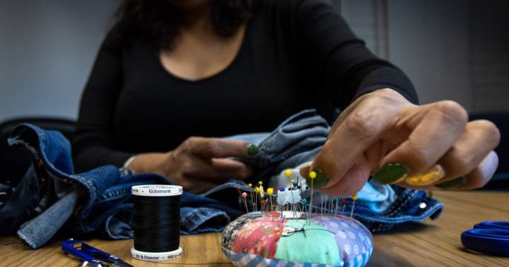 ‘Stitched it back’: Edmonton event where locals mend clothes promotes sustainability