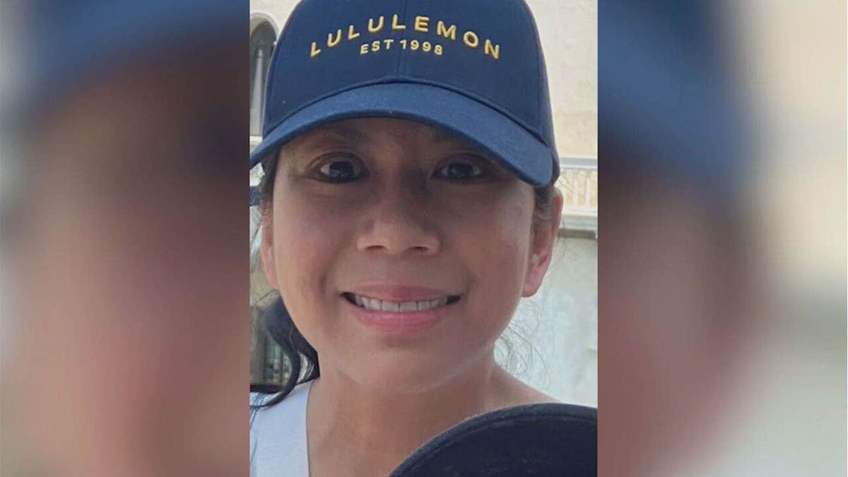 Portrait of Antoinette Forbes smiling while wearing a navy blue baseball cap