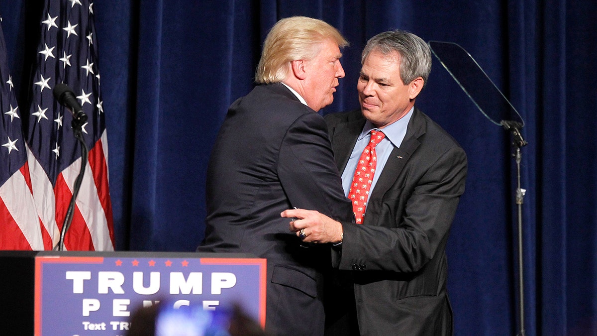 Bert Mizusawa hugs Trump.