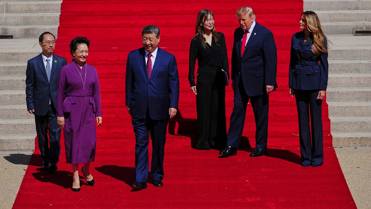 President Donald Trump and first lady Melania Trump greet China's President Xi Jinping and his wife Peng Liyuan at the National Archives Museum.